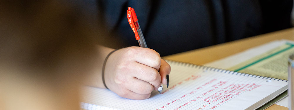 CU Denver student's hand handwriting notes in a notebook